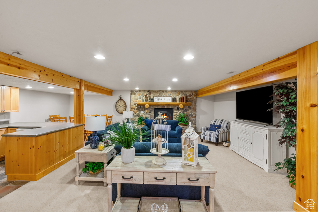 Living room with a fireplace, light carpet, and recessed lighting