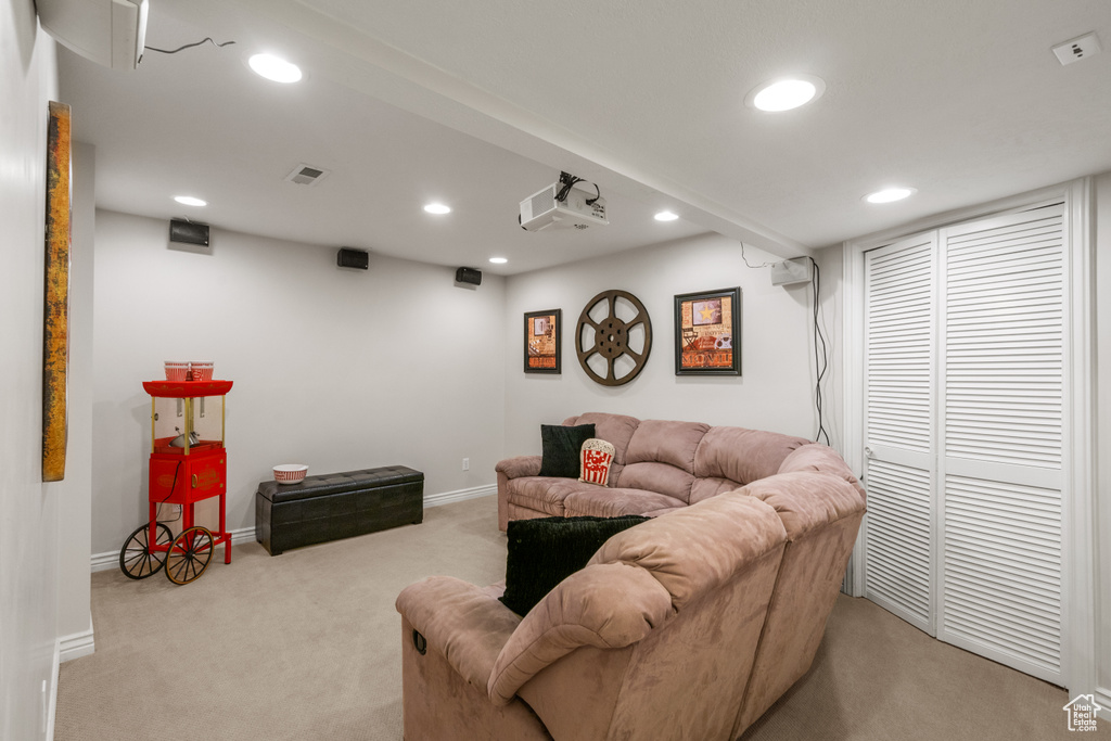 Carpeted living area featuring recessed lighting, baseboards, and visible vents