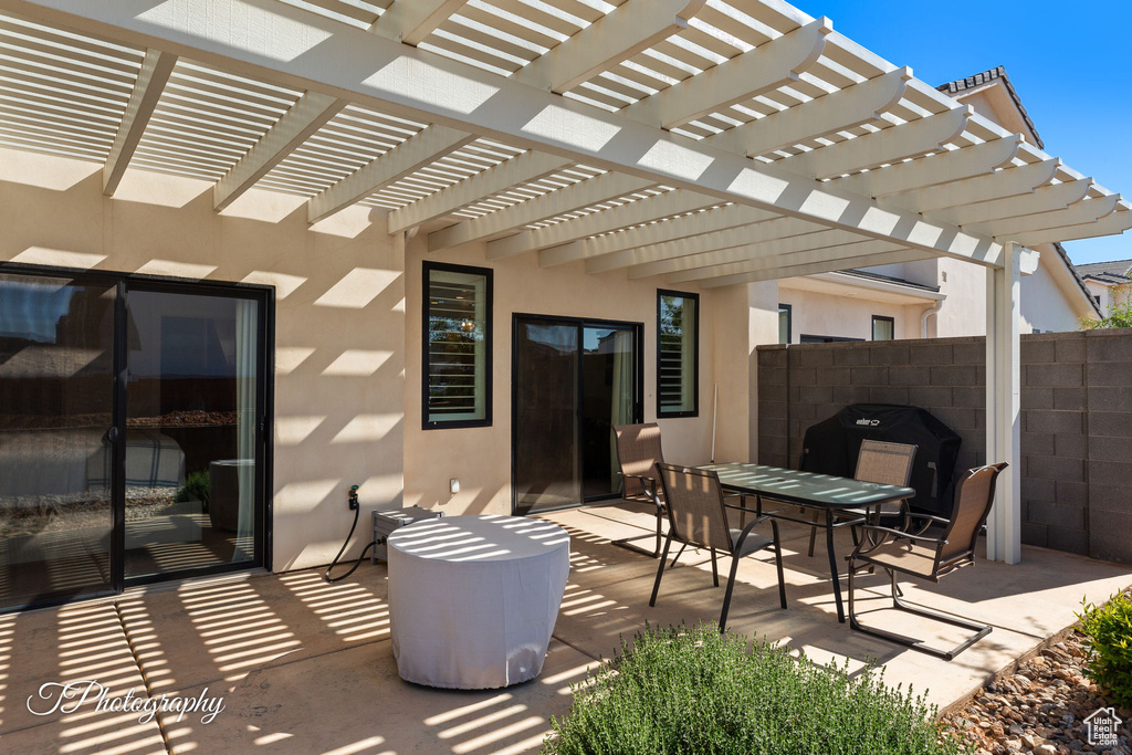 View of patio / terrace featuring a pergola, fence, and outdoor dining area
