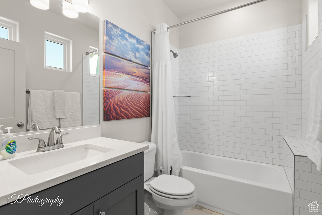 Full bathroom with vanity, toilet, and shower / bath combo