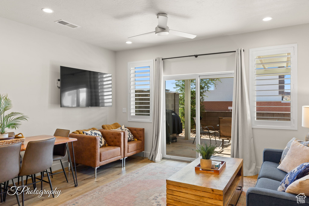 Living area featuring a ceiling fan, recessed lighting, light wood-style flooring, and visible vents