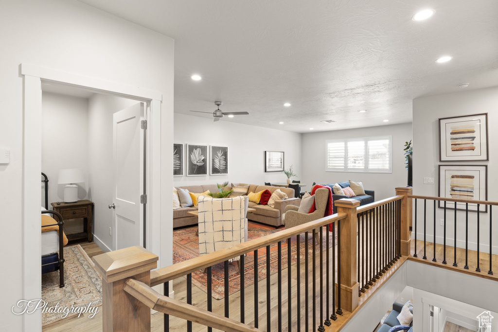 Living room with ceiling fan, recessed lighting, and wood finished floors