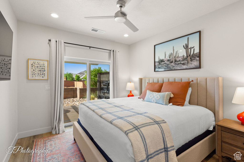 Bedroom with wood finished floors, access to exterior, visible vents, baseboards, and recessed lighting