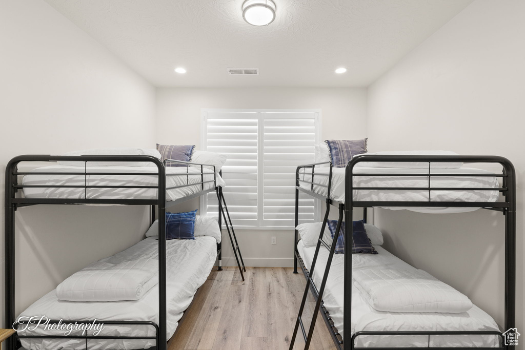 Bedroom featuring recessed lighting, baseboards, visible vents, and wood finished floors