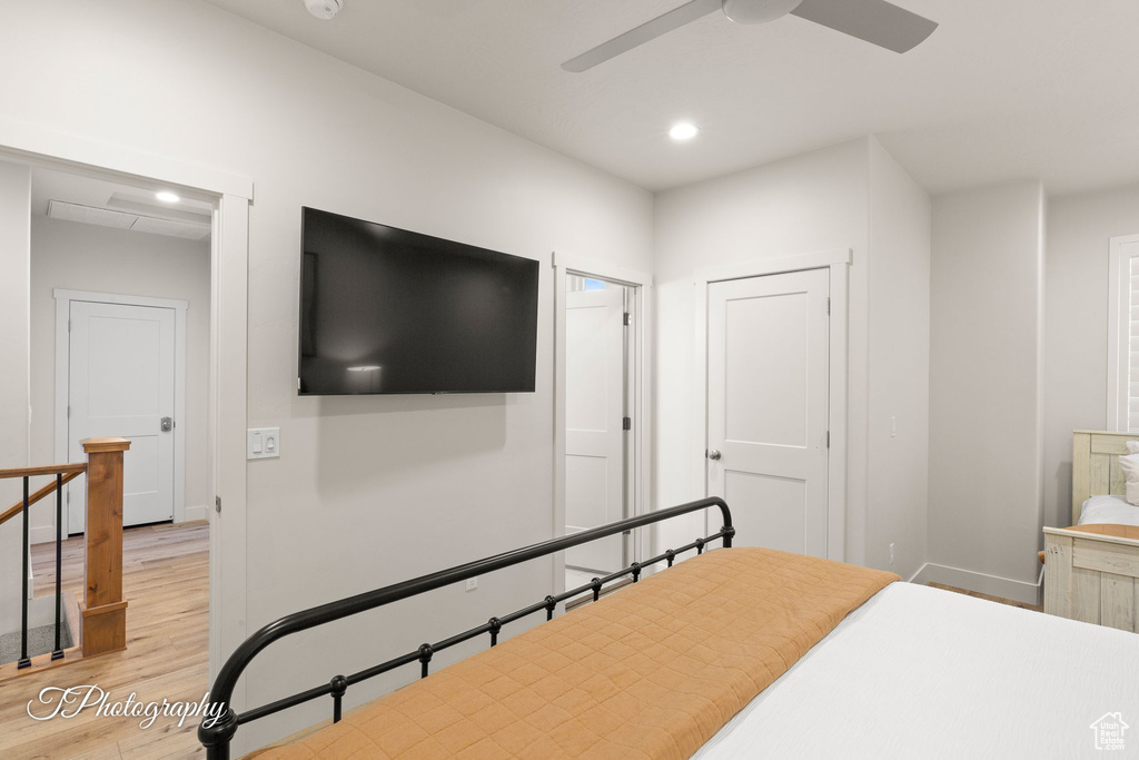 Bedroom featuring baseboards, ceiling fan, light wood-style flooring, and recessed lighting