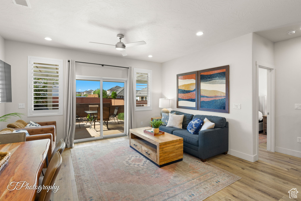 Living room with a ceiling fan, recessed lighting, and light wood-type flooring
