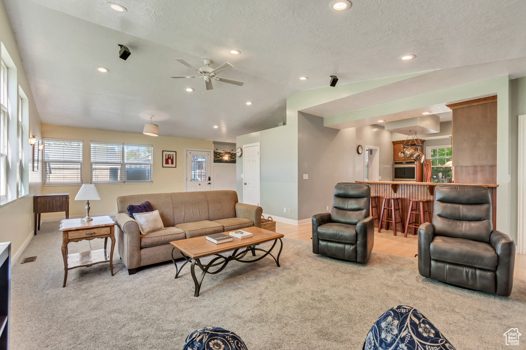 Living area featuring baseboards, recessed lighting, carpet floors, and vaulted ceiling