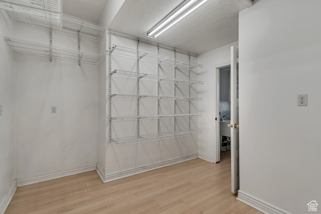 Spacious closet with wood finished floors