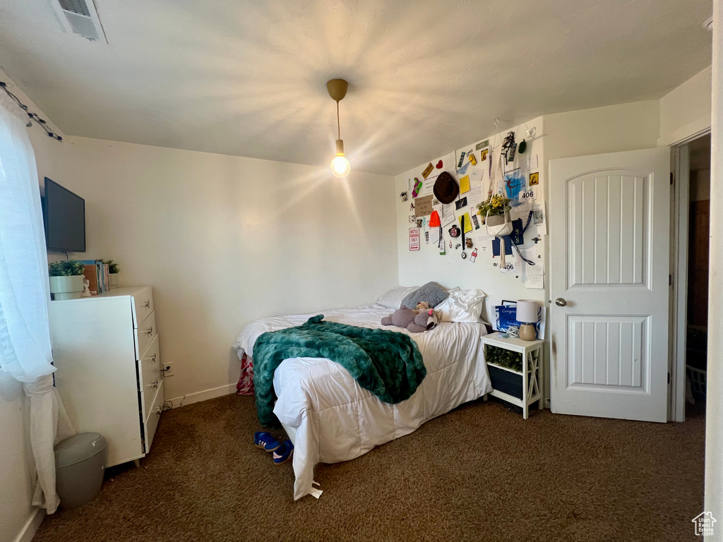 Bedroom featuring carpet, baseboards, and visible vents