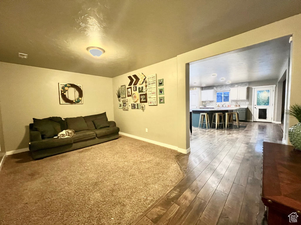 Living area with dark wood finished floors and baseboards