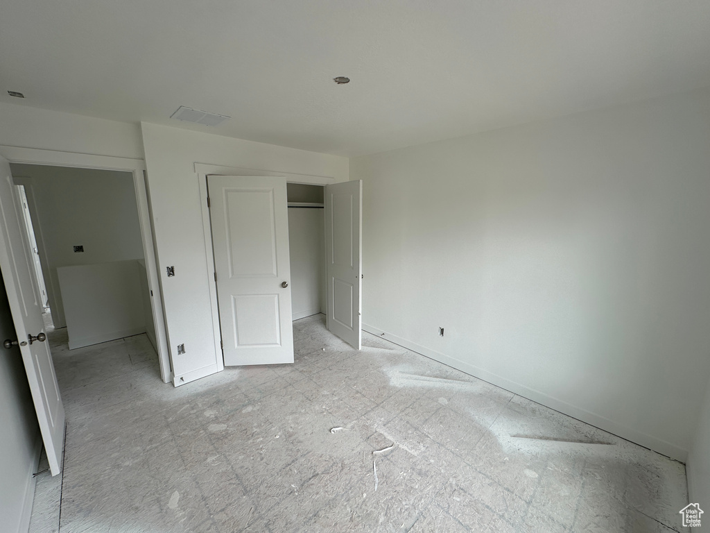 Unfurnished bedroom featuring a closet and visible vents
