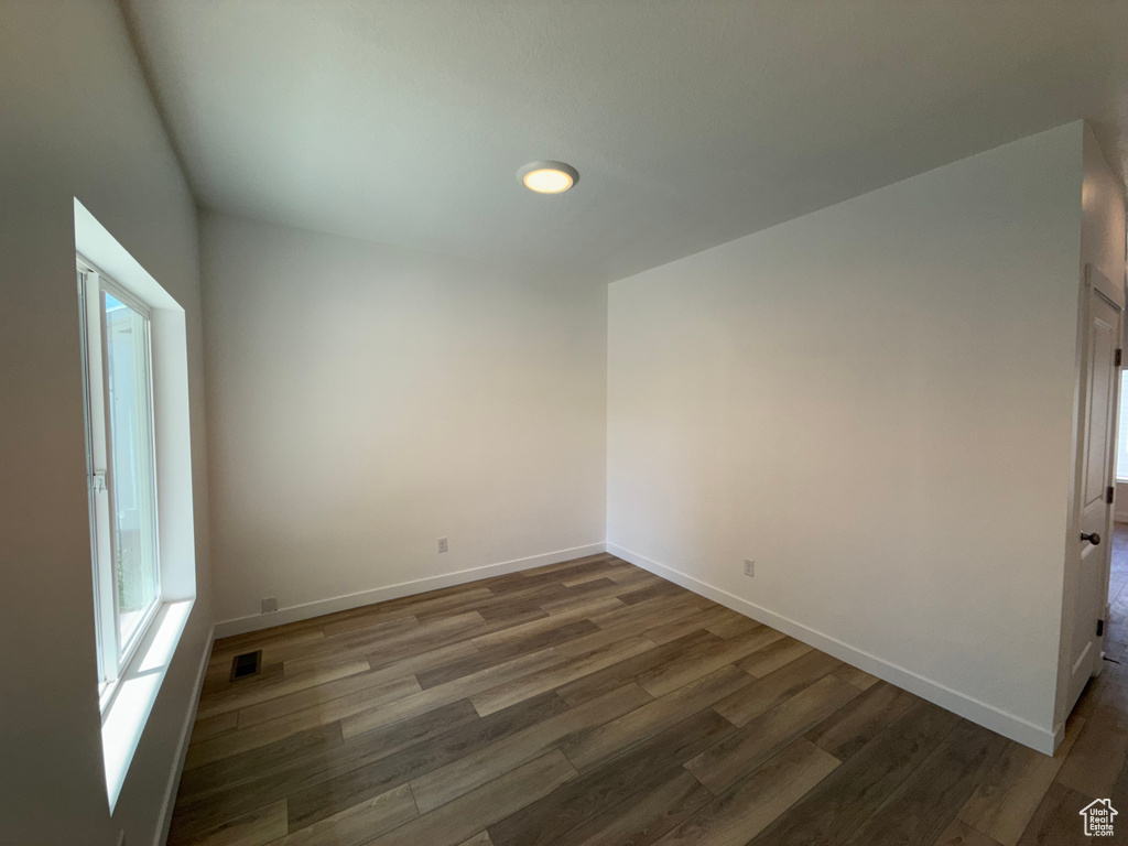 Empty room featuring wood finished floors and recessed lighting
