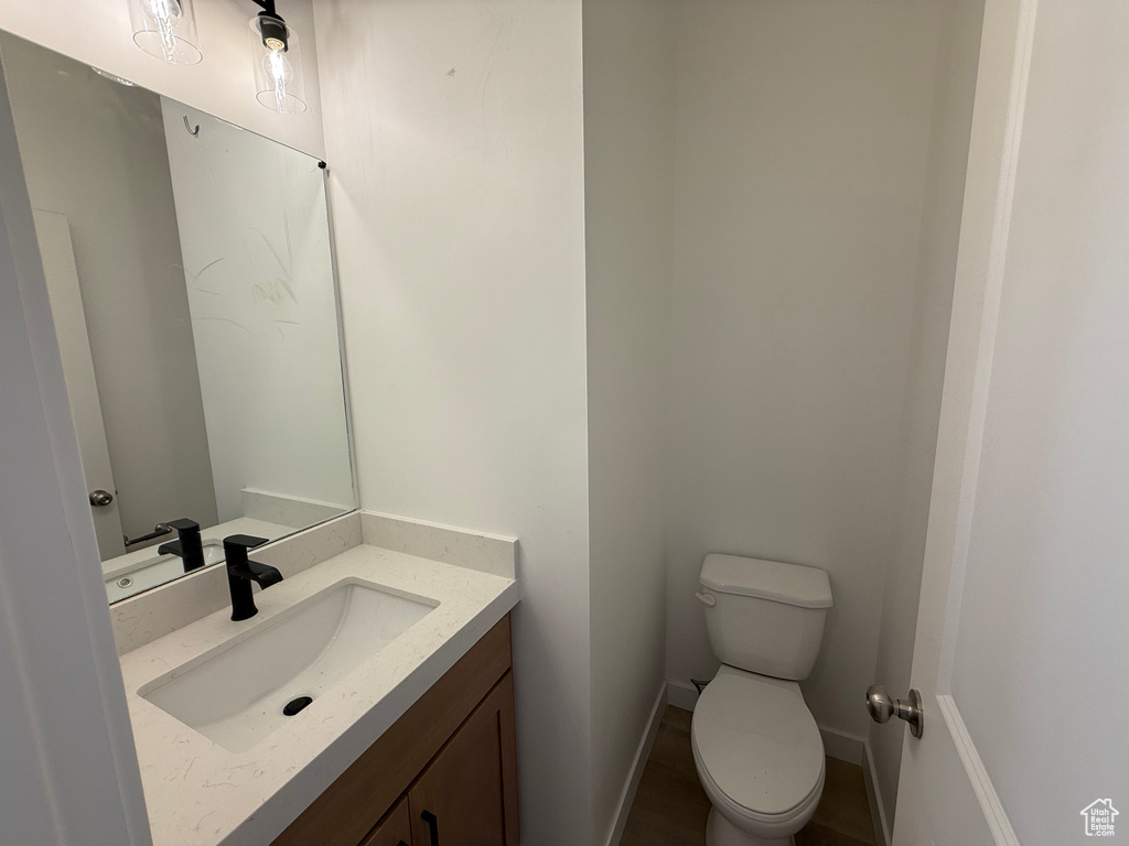 Half bathroom with vanity and toilet