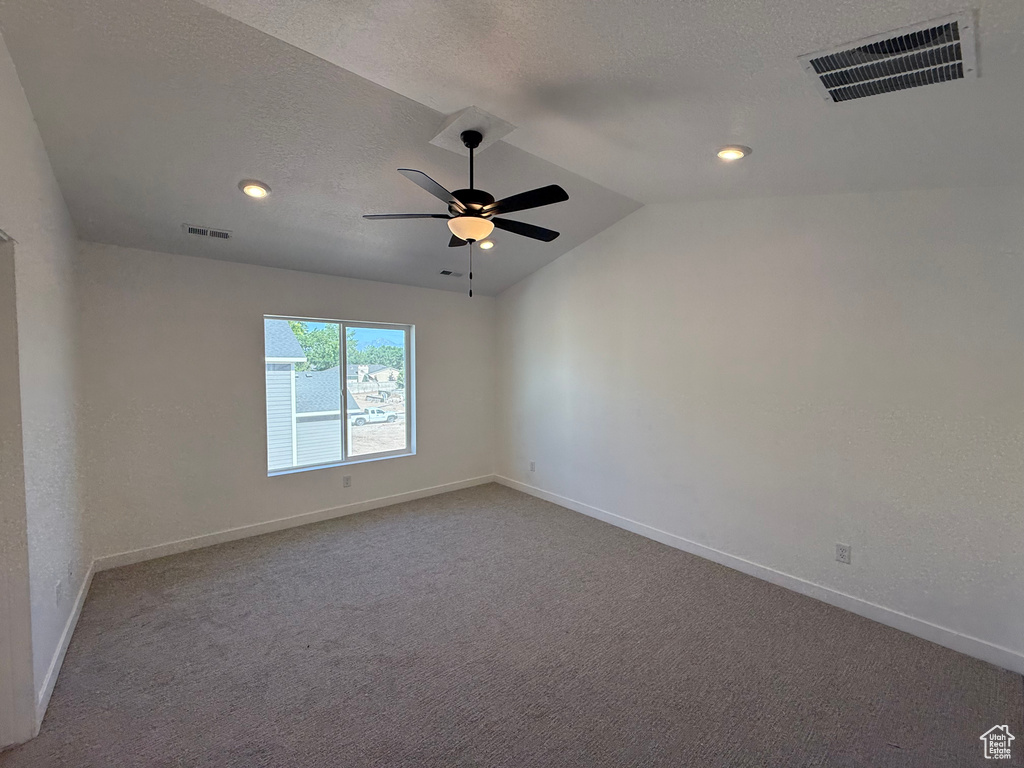 Carpeted empty room with vaulted ceiling, ceiling fan, a textured ceiling, and recessed lighting