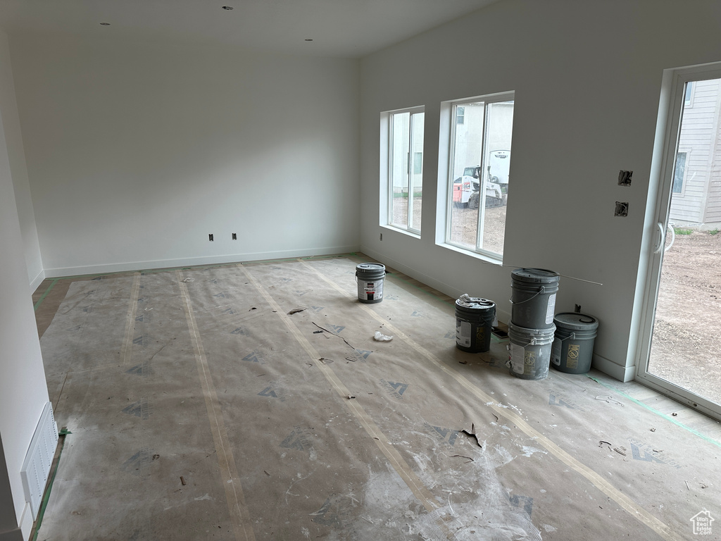 Unfurnished living room with a wealth of natural light and visible vents