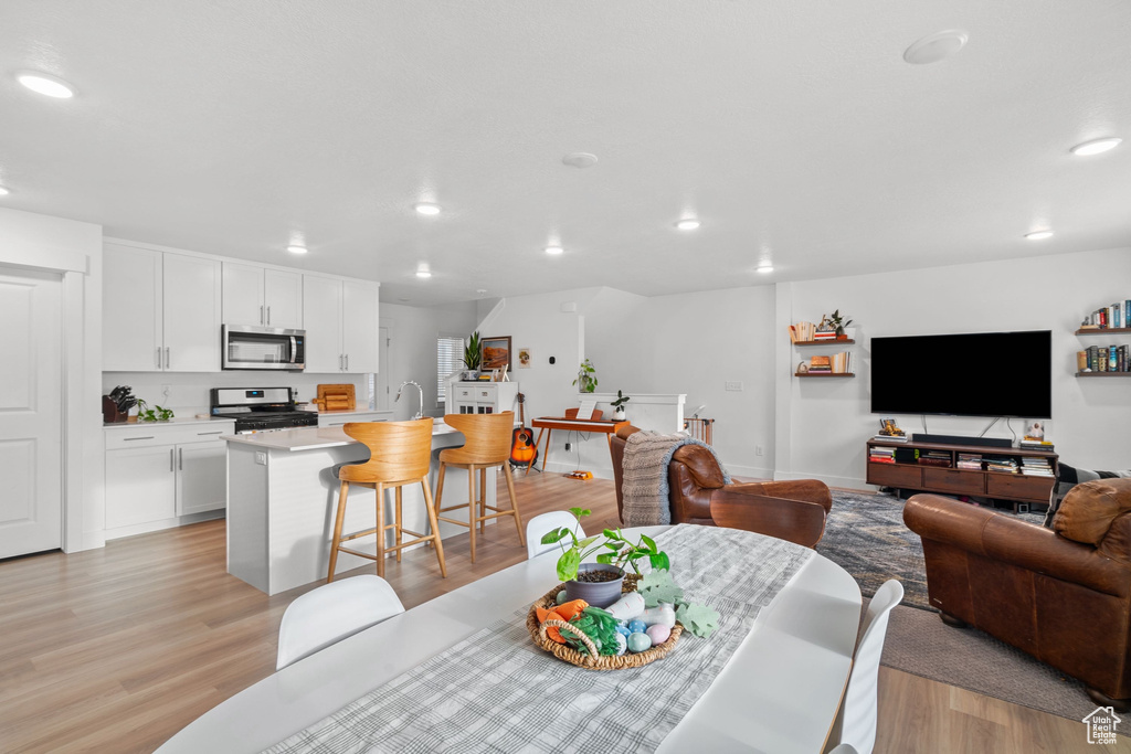 Dining room featuring recessed lighting and light wood-style floors