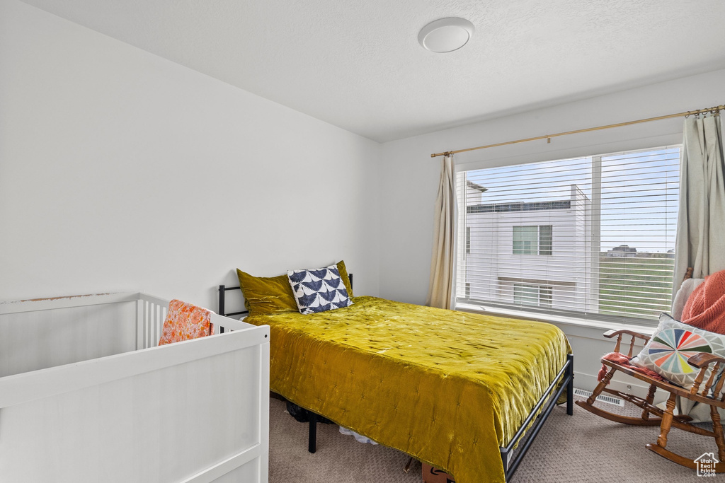 Bedroom featuring baseboards and carpet flooring