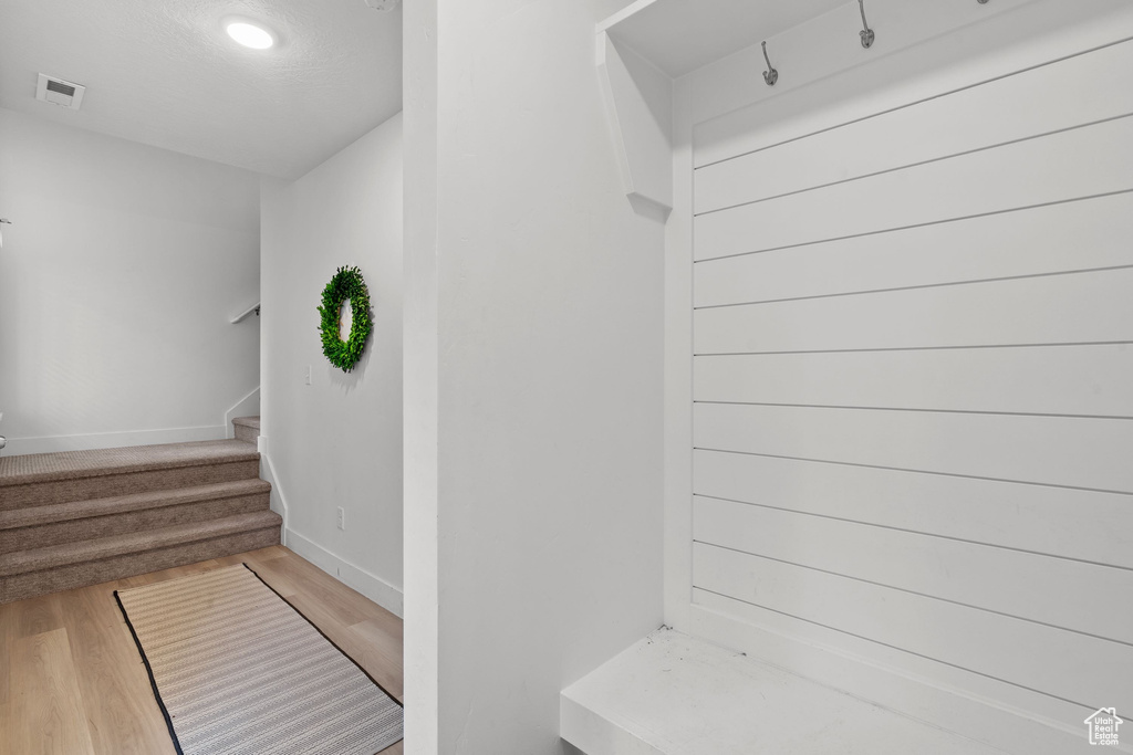 Mudroom featuring visible vents, wood finished floors, and baseboards