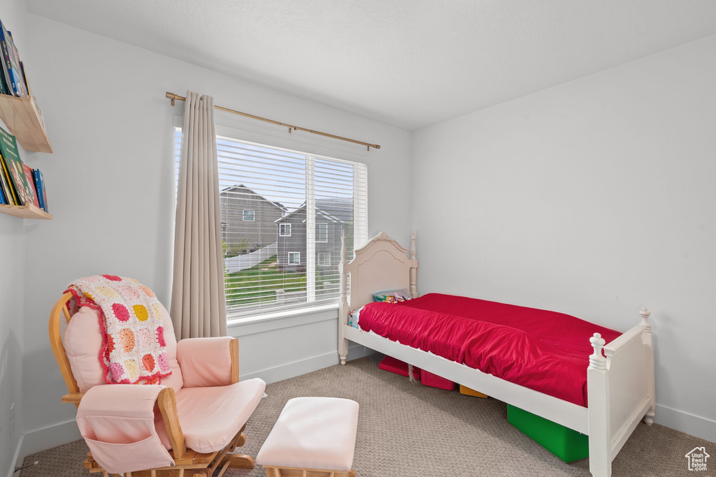 Carpeted bedroom with baseboards