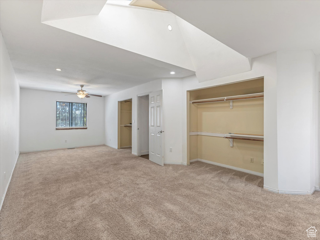 Unfurnished bedroom with two closets, carpet floors, baseboards, and recessed lighting