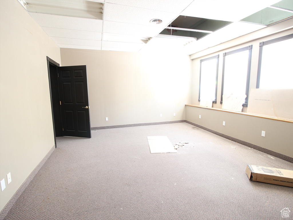 Carpeted spare room featuring baseboards and visible vents