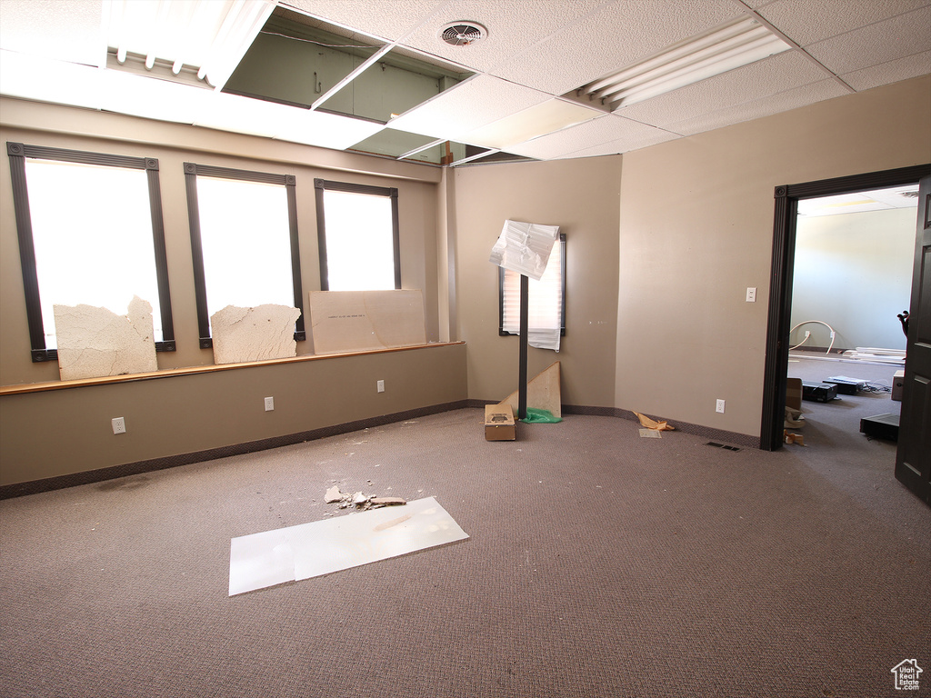 Carpeted spare room featuring visible vents and baseboards
