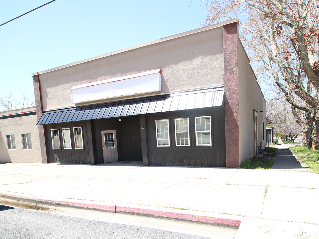 Contemporary house with metal roof, stucco siding, and a standing seam roof