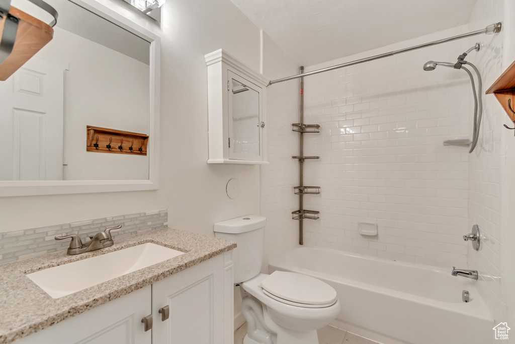 Bathroom with  shower combination, toilet, decorative backsplash, and vanity