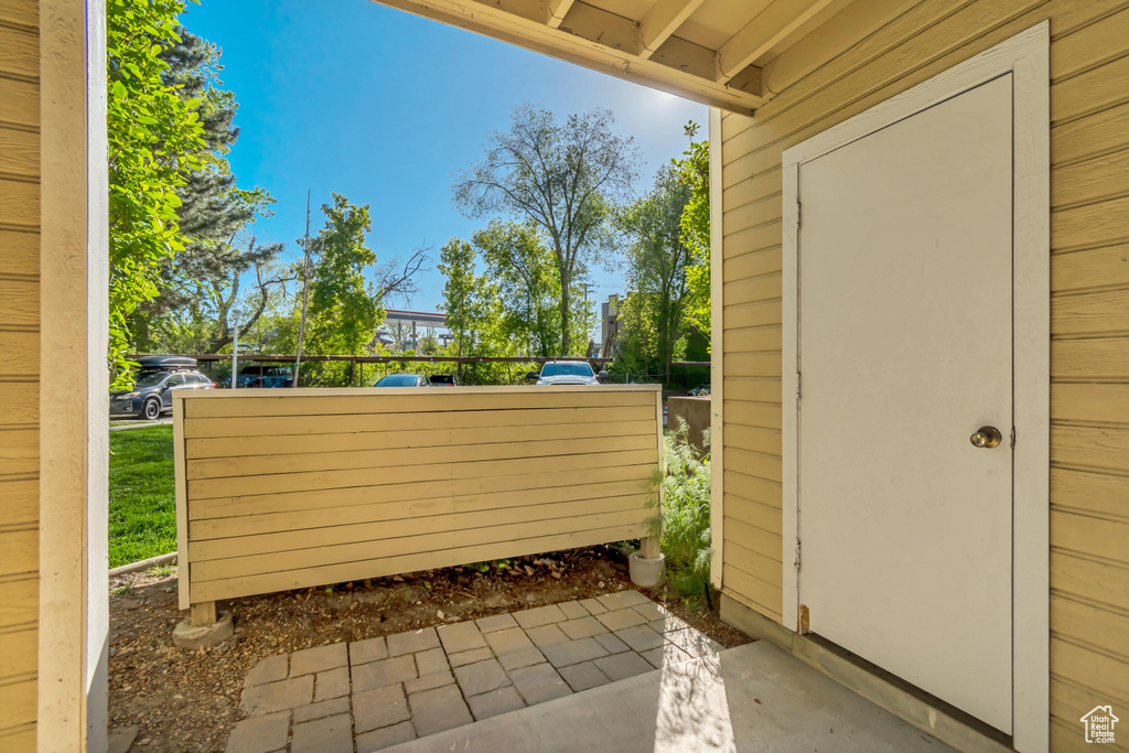 View of patio featuring fence