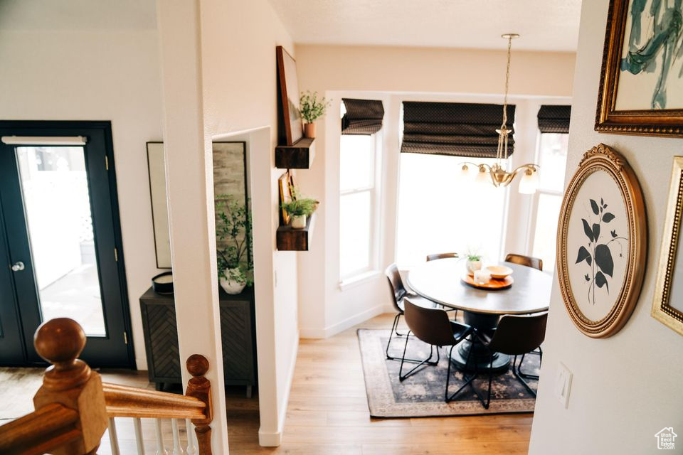 Dining space with baseboards and light wood-style flooring