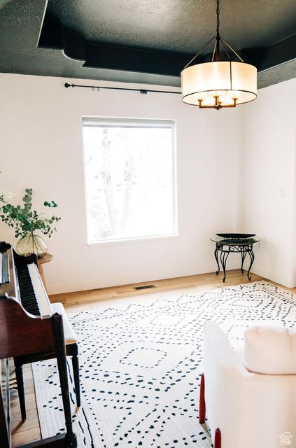 Living area featuring visible vents and wood finished floors