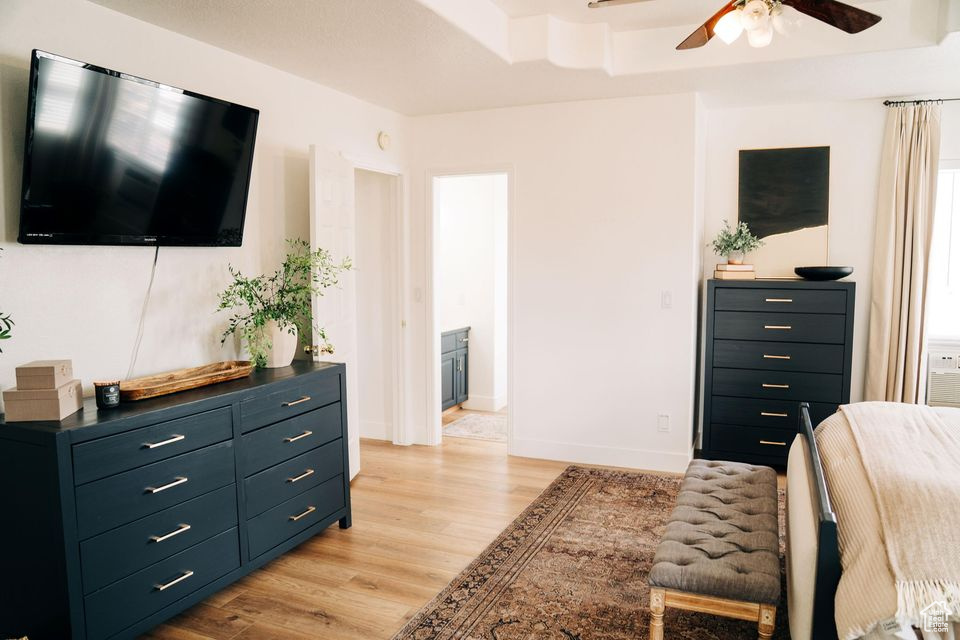 Bedroom with baseboards, light wood-type flooring, and a ceiling fan