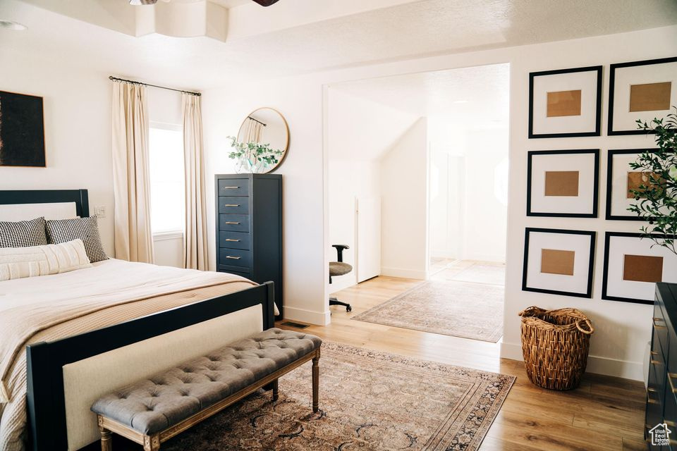 Bedroom with baseboards and wood finished floors