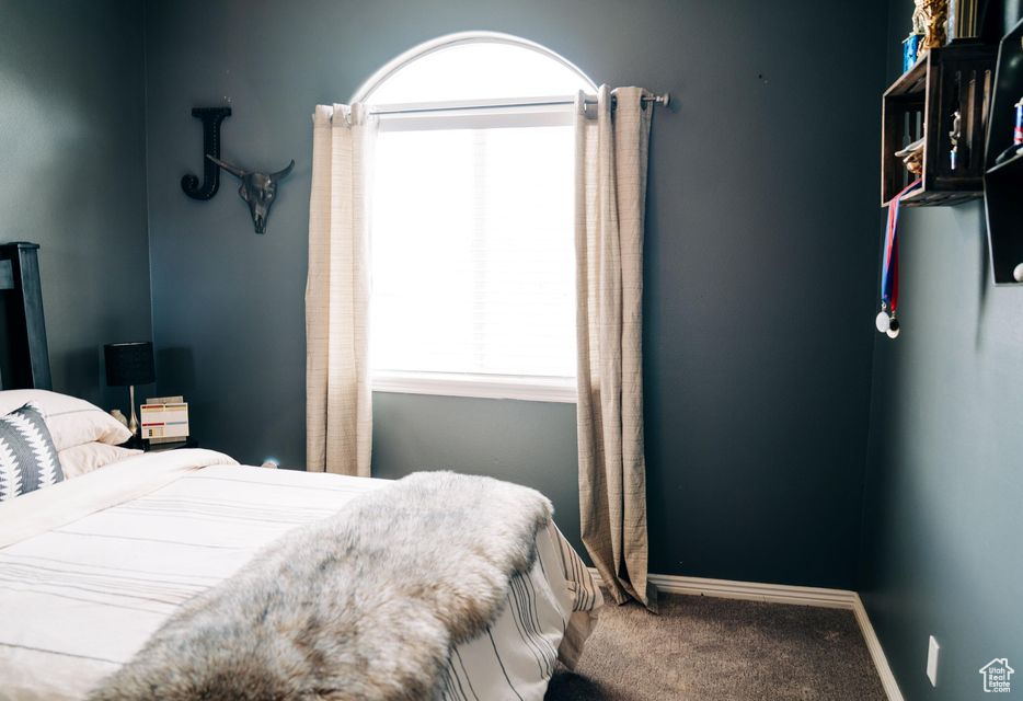Carpeted bedroom with baseboards