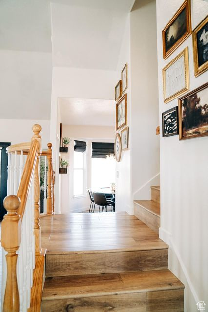 Stairs featuring wood finished floors