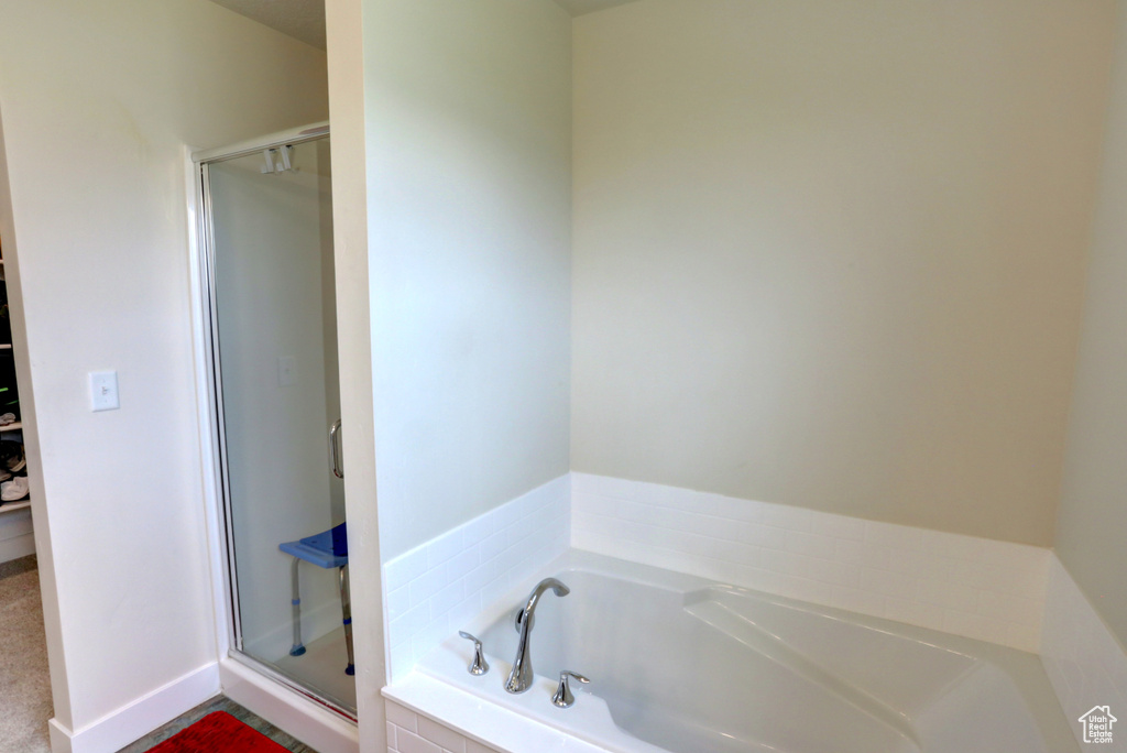 Bathroom with a garden tub and a shower stall