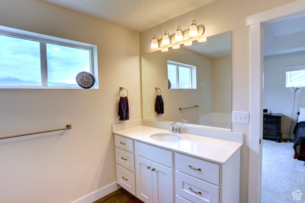 Bathroom featuring baseboards and vanity