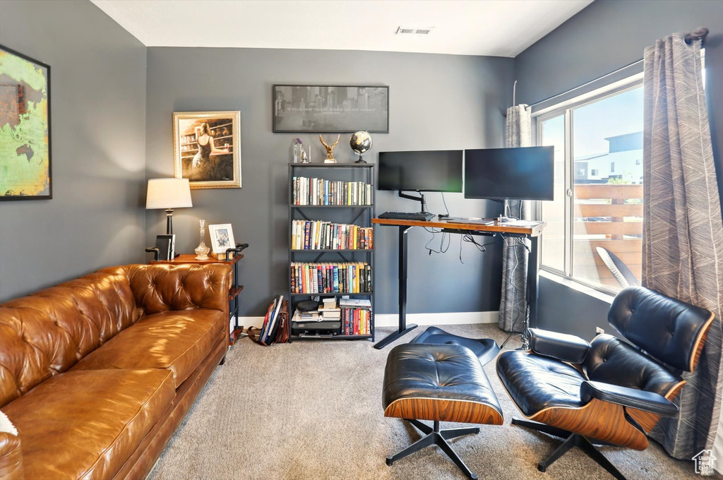 Living room with baseboards, carpet flooring, and visible vents