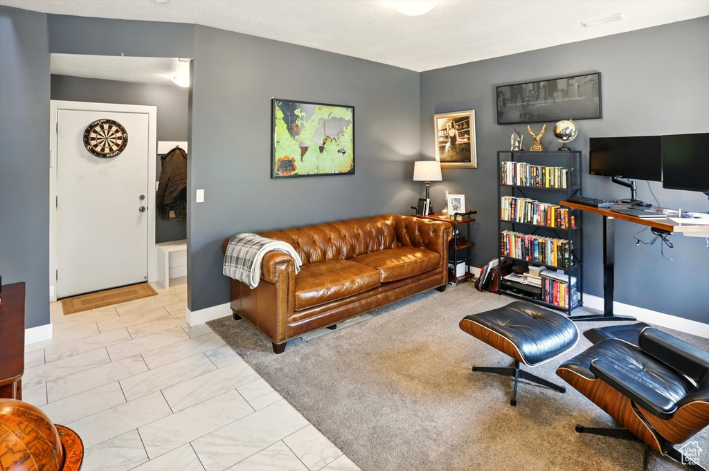 Living room featuring baseboards and marble finish floor