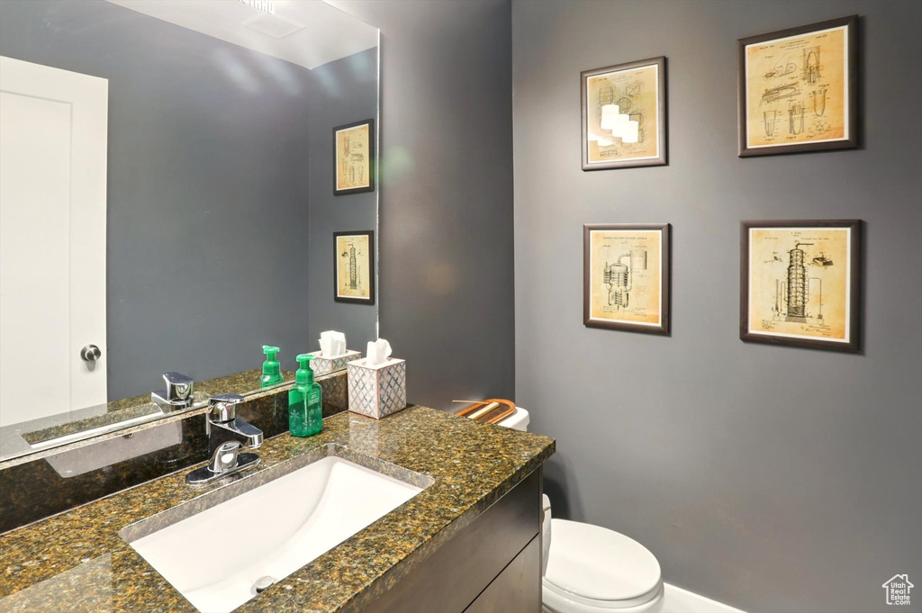 Half bath with vanity and toilet
