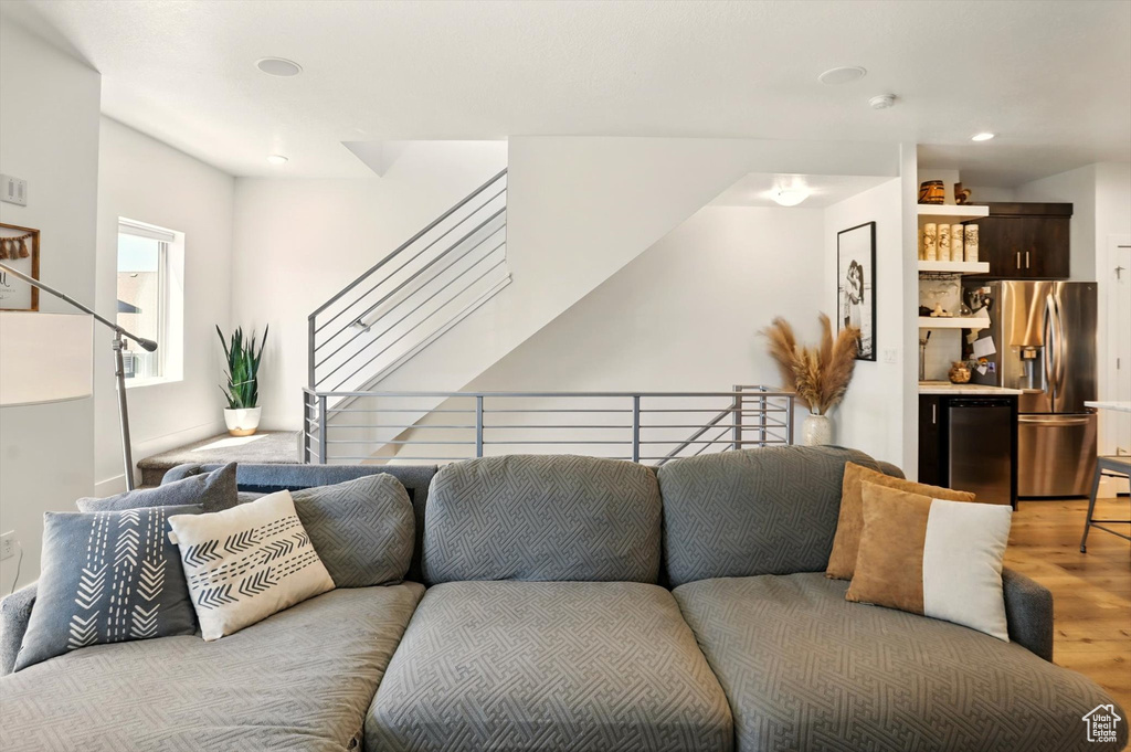 Living area with stairs, light wood-type flooring, and recessed lighting