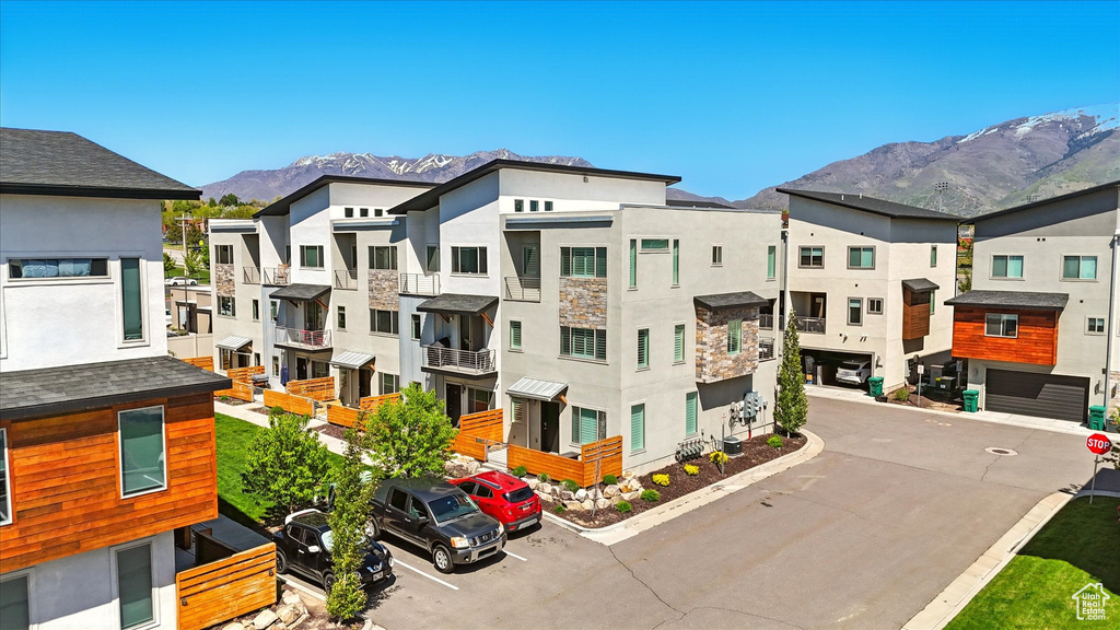 View of property with a mountain view and a residential view