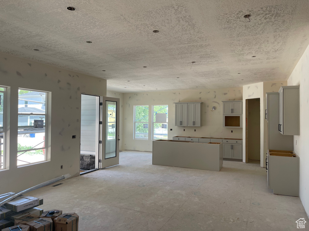Unfurnished living room with a textured ceiling