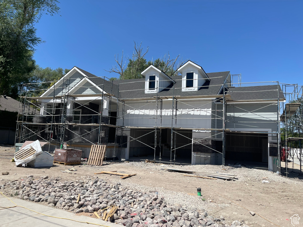 Property in mid-construction featuring a shingled roof