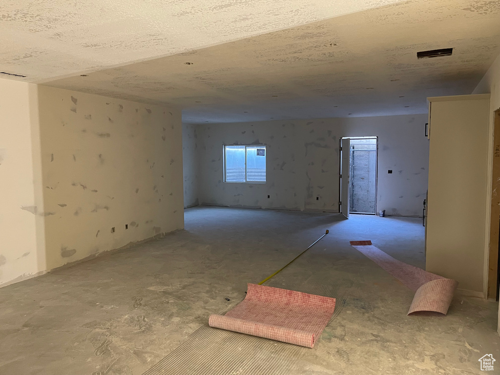 Unfurnished room featuring a textured ceiling