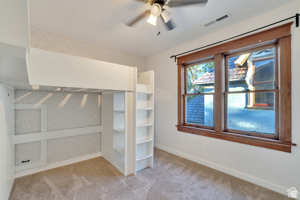 Unfurnished bedroom featuring baseboards, visible vents, and carpet