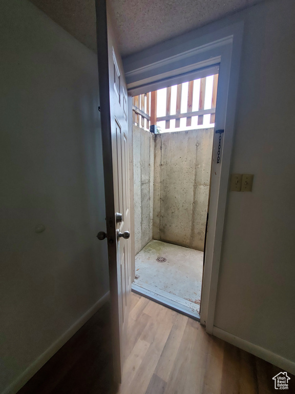 Bathroom featuring a textured ceiling and wood finished floors