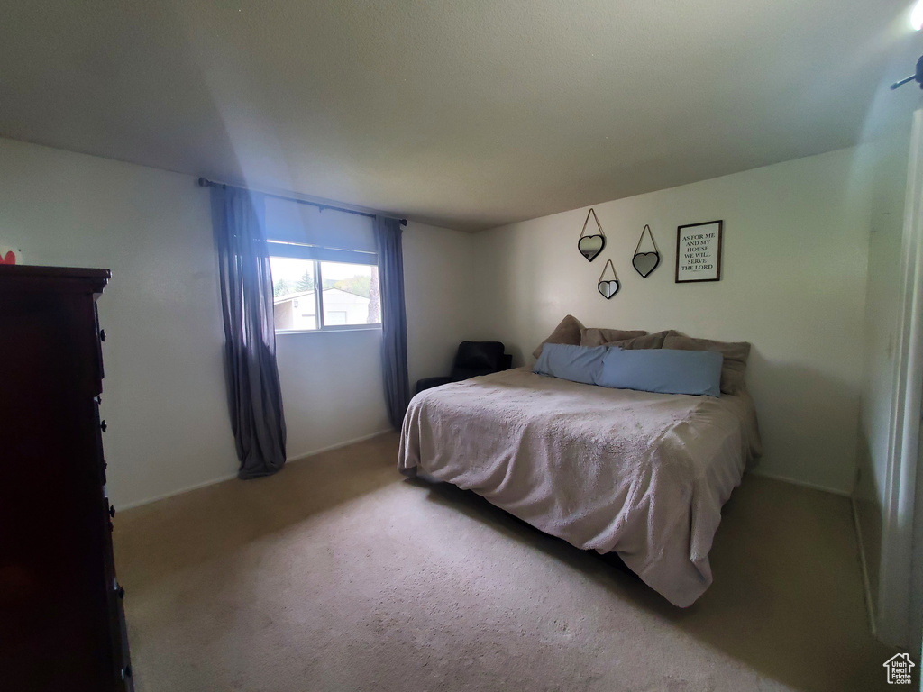 Carpeted bedroom featuring baseboards