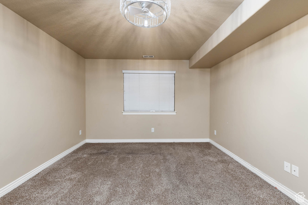 Carpeted spare room with baseboards and visible vents
