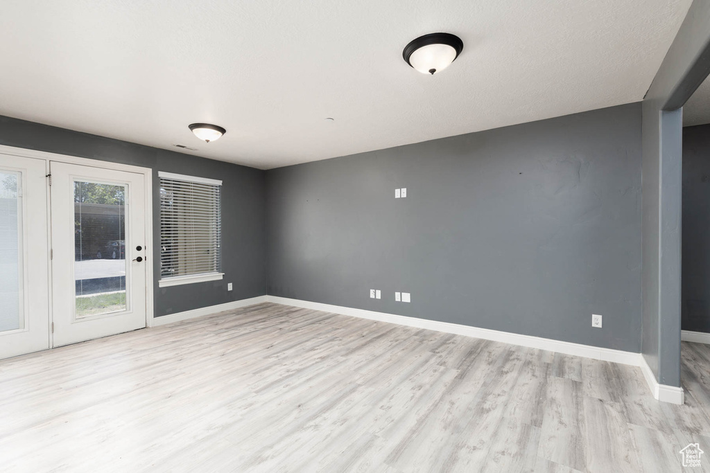 Empty room featuring light wood finished floors and baseboards